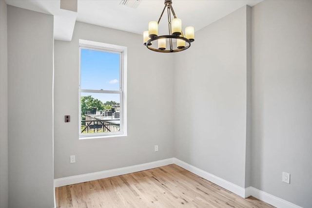 159 14th St Unit 4R, Hoboken, NJ 07030 - empty room featuring a chandelier, plenty of natural light, and light wood-type flooring