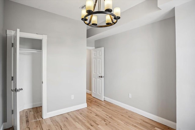 159 14th St Unit 4R, Hoboken, NJ 07030 - unfurnished bedroom featuring a chandelier, wood finished floors, and a closet