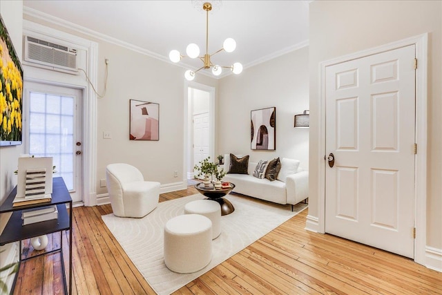 living room featuring an inviting chandelier, crown molding, light hardwood / wood-style floors, and a wall mounted AC