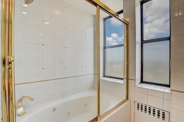 bathroom featuring enclosed tub / shower combo and radiator