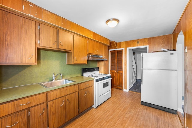 11 Veterans Ct, Bayonne, NJ 07002 - kitchen featuring white appliances, under cabinet range hood, brown cabinets, light wood-type flooring, and light countertops