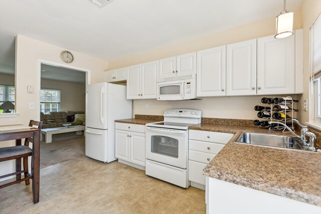 1072 Argyll Cir, Lakewood Township, NJ 08701 - kitchen with white appliances, a sink, white cabinets, and decorative light fixtures