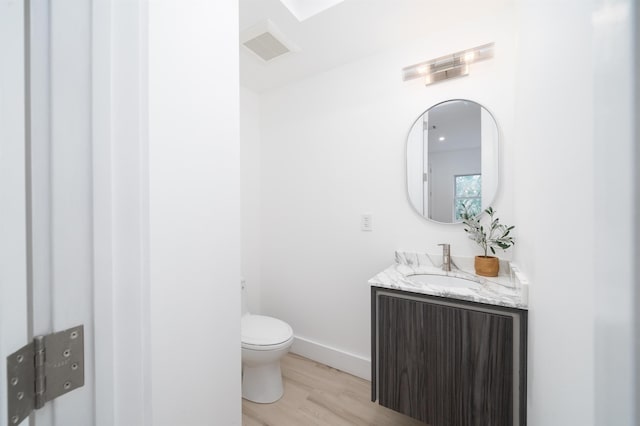90 Monroe St Unit 2, Hoboken, NJ 07030 - half bathroom featuring wood finished floors, toilet, and vanity