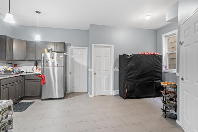 218 68th St, Guttenberg, NJ 07093 - kitchen with freestanding refrigerator, hanging light fixtures, light stone countertops, and gray cabinetry