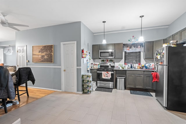 218 68th St, Guttenberg, NJ 07093 - kitchen with appliances with stainless steel finishes, a ceiling fan, decorative light fixtures, tasteful backsplash, and gray cabinets