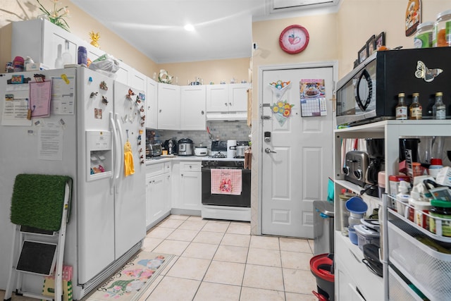 218 68th St, Guttenberg, NJ 07093 - kitchen featuring gas range oven, white refrigerator with ice dispenser, under cabinet range hood, light tile patterned flooring, and tasteful backsplash