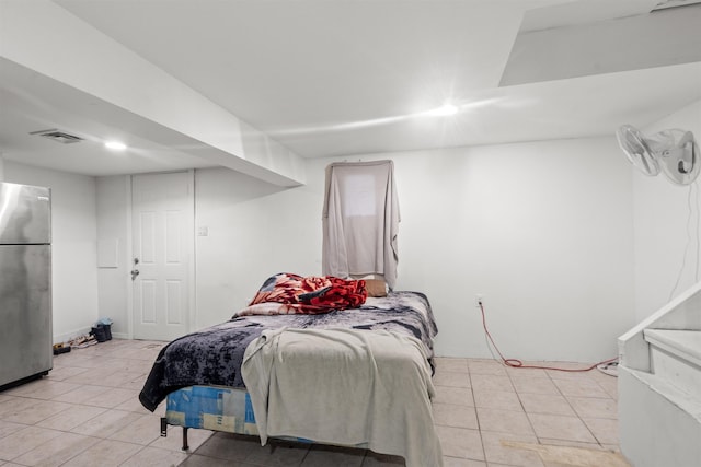 218 68th St, Guttenberg, NJ 07093 - bedroom with freestanding refrigerator and light tile patterned floors