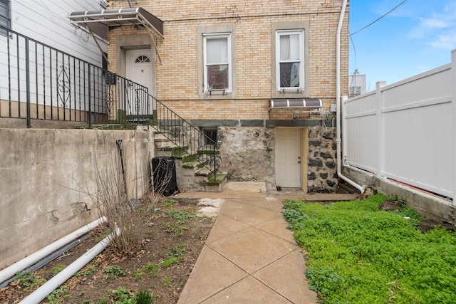 218 68th St, Guttenberg, NJ 07093 - back of property with brick siding and stairs