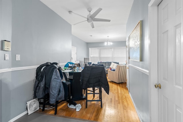 218 68th St, Guttenberg, NJ 07093 - dining space with light wood-style floors, a ceiling fan, and a chandelier