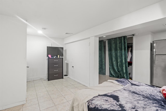 218 68th St, Guttenberg, NJ 07093 - bedroom featuring freestanding refrigerator and light tile patterned floors