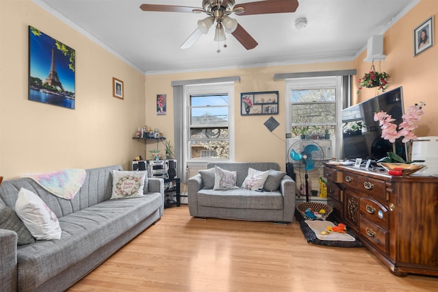 218 68th St, Guttenberg, NJ 07093 - living area with light wood-style flooring, ceiling fan, crown molding, and a baseboard radiator