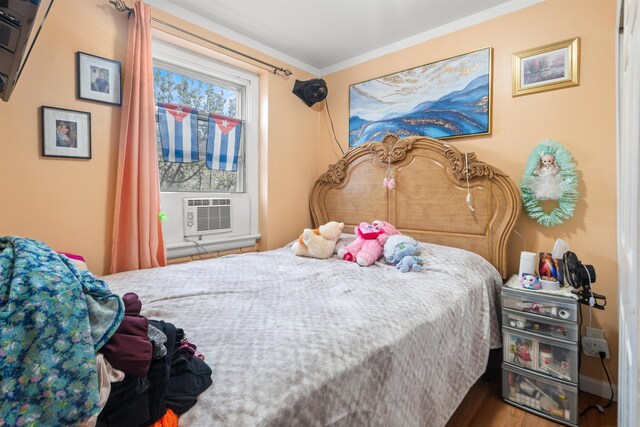 218 68th St, Guttenberg, NJ 07093 - bedroom with cooling unit, wood finished floors, and crown molding