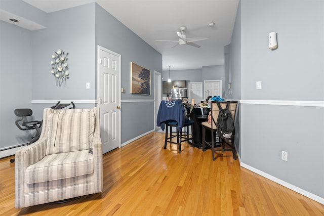 218 68th St, Guttenberg, NJ 07093 - living area with light wood finished floors, a ceiling fan, and a baseboard radiator