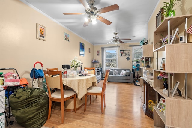 218 68th St, Guttenberg, NJ 07093 - dining area with ceiling fan, light wood finished floors, and crown molding