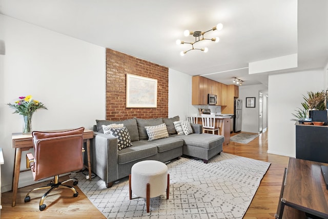 118 Clinton St Unit 7, Hoboken, NJ 07030 - living room with a chandelier, light wood-style flooring, and baseboards