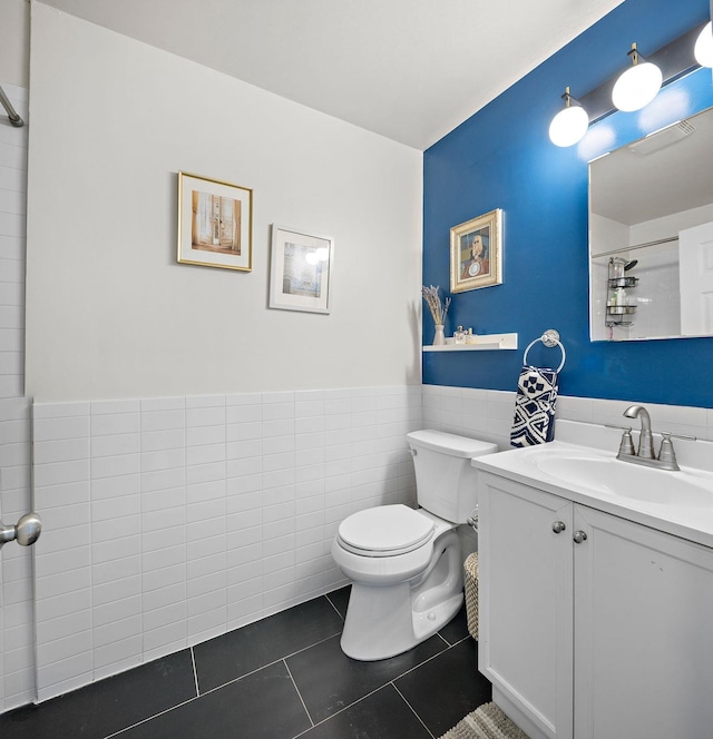 118 Clinton St Unit 7, Hoboken, NJ 07030 - bathroom with toilet, vanity, tile patterned floors, a wainscoted wall, and a shower