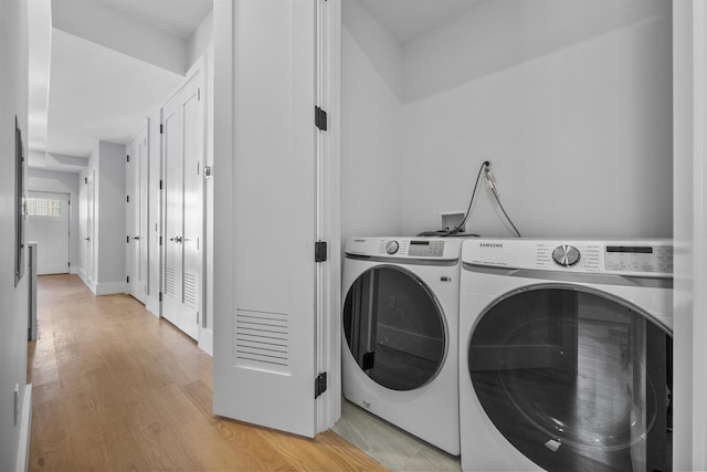 13 Manhattan Ave Unit 1, Jersey City, NJ 07307 - laundry area featuring washer and dryer and light wood finished floors