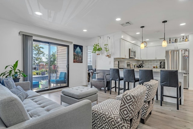 539 Bayway Cir Unit 2C, Elizabeth, NJ 07202 - living room with light wood-style floors and recessed lighting