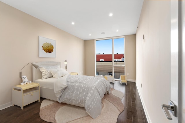bedroom featuring dark wood-type flooring, recessed lighting, and baseboards