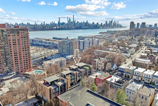 birds eye view of property with a view of city and a water view