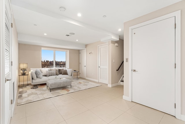 living room featuring light tile patterned flooring, stairs, recessed lighting, baseboards, and visible vents