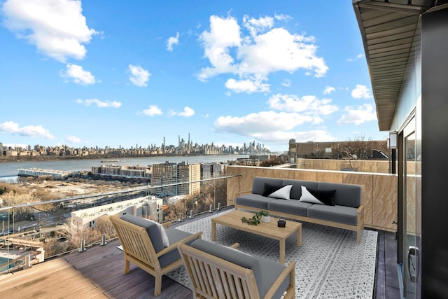 wooden deck with a view of city, a water view, and outdoor lounge area