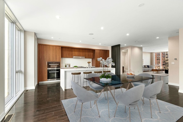 dining room with visible vents, dark wood finished floors, and plenty of natural light