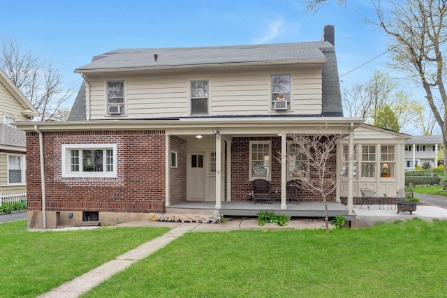 rear view of house featuring a lawn, a chimney, brick siding, and cooling unit