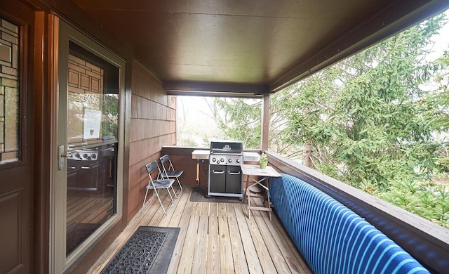 wooden deck featuring a grill