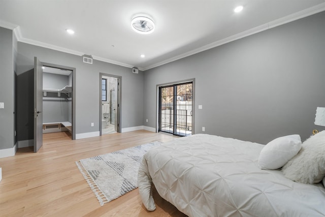 bedroom featuring baseboards, visible vents, light wood-style flooring, and ornamental molding