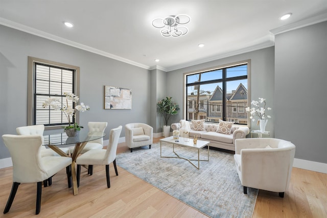 living room with light wood finished floors, plenty of natural light, ornamental molding, and baseboards