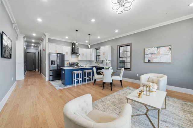 living room featuring ornamental molding, recessed lighting, light wood-style flooring, and baseboards