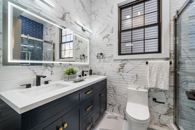 full bathroom with marble finish floor, double vanity, toilet, a stall shower, and a sink