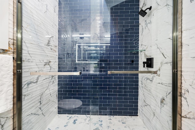 full bath with a marble finish shower