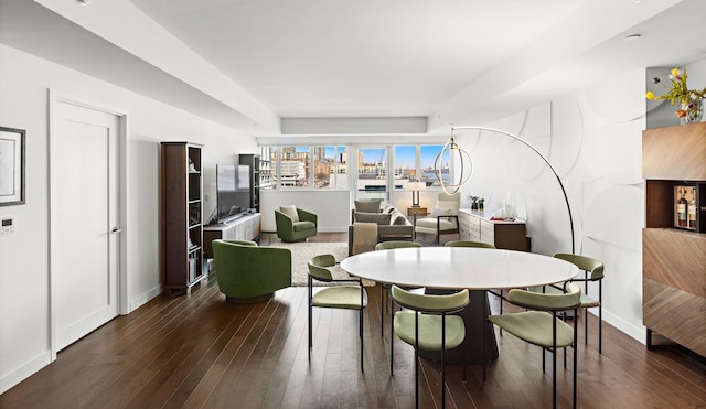 dining area featuring baseboards and dark wood-style flooring