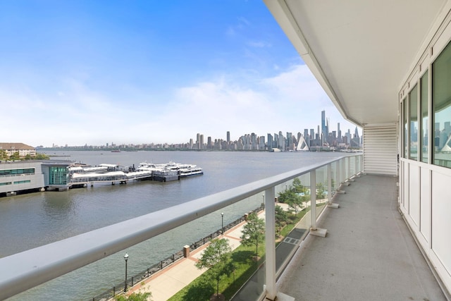 balcony with a water view and a city view