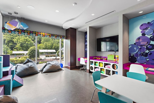 recreation room featuring recessed lighting and concrete flooring