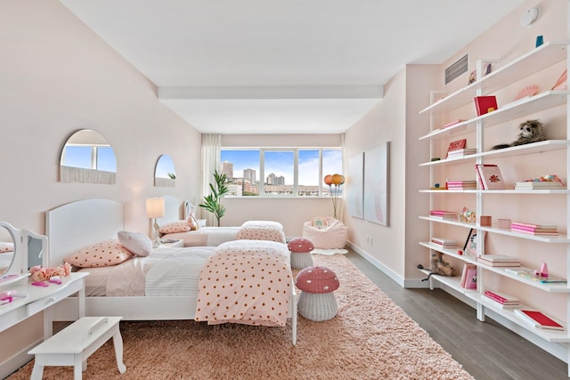 bedroom with baseboards and dark wood-style floors