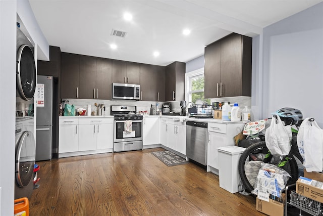 70 County Ave, Secaucus, NJ 07094 - kitchen featuring appliances with stainless steel finishes, stacked washing machine and dryer, light countertops, tasteful backsplash, and recessed lighting