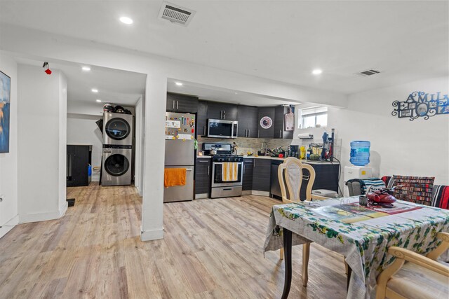 70 County Ave, Secaucus, NJ 07094 - dining room featuring stacked washer and clothes dryer, light wood-style floors, recessed lighting, and baseboards