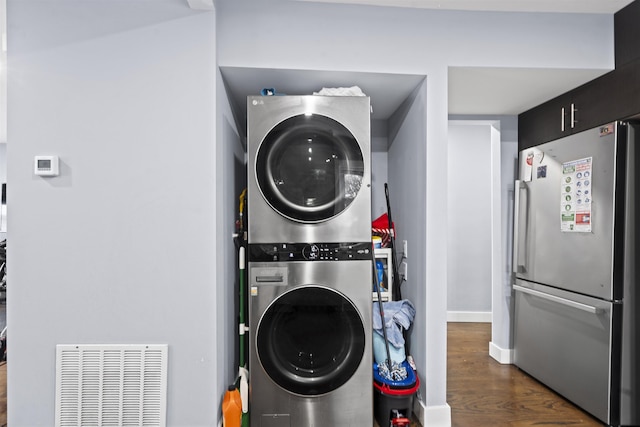 70 County Ave, Secaucus, NJ 07094 - laundry room featuring stacked washer / drying machine, dark wood finished floors, and baseboards
