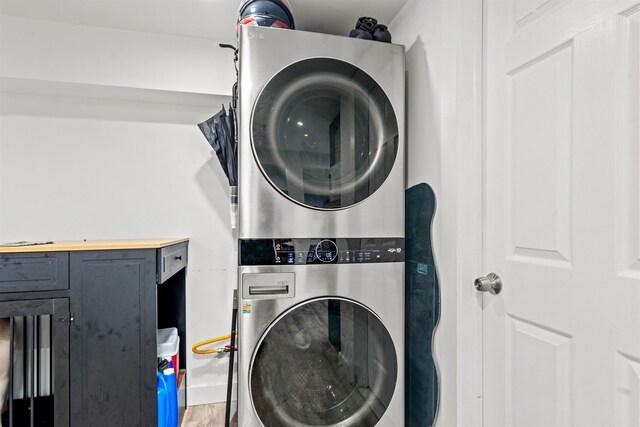 70 County Ave, Secaucus, NJ 07094 - laundry room with stacked washer and clothes dryer and wood finished floors