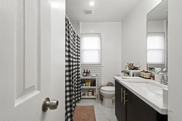 70 County Ave, Secaucus, NJ 07094 - full bathroom with marble look tile flooring, toilet, vanity, and curtained shower