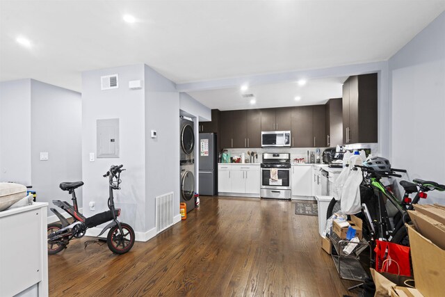 70 County Ave, Secaucus, NJ 07094 - kitchen featuring appliances with stainless steel finishes, estacked washer and dryer, electric panel, light countertops, and dark wood-style floors