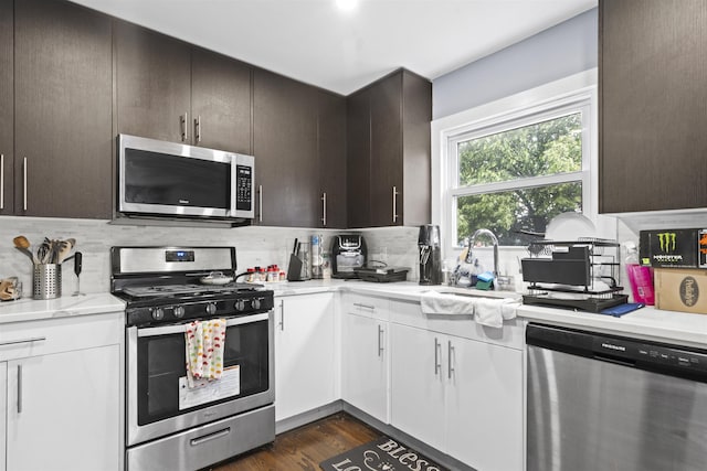 70 County Ave, Secaucus, NJ 07094 - kitchen with appliances with stainless steel finishes, tasteful backsplash, a sink, dark brown cabinetry, and dark wood-type flooring