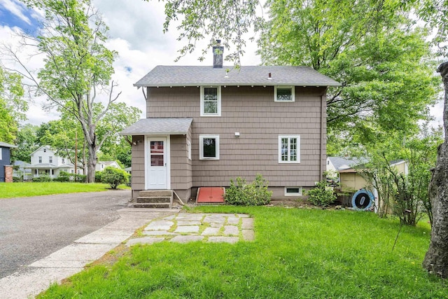 468 Van Buren St, Ridgewood, NJ 07450 - back of house with a chimney, a lawn, and a shingled roof