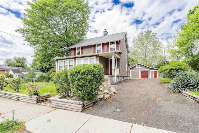 468 Van Buren St, Ridgewood, NJ 07450 - view of front facade featuring a detached garage, an outdoor structure, and a chimney