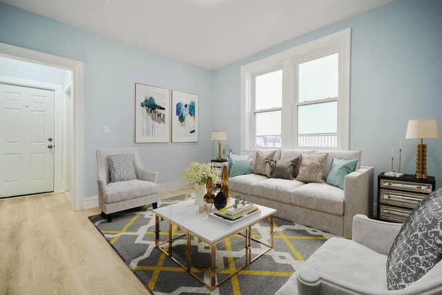 additional living space with radiator and light hardwood / wood-style flooring