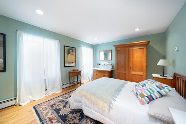288 Barrow St Unit 2, Jersey City, NJ 07302 - bedroom with baseboard heating, wood finished floors, and recessed lighting