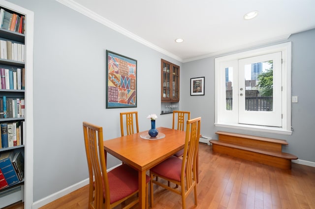 288 Barrow St Unit 2, Jersey City, NJ 07302 - dining room featuring crown molding, baseboard heating, wood-type flooring, and recessed lighting